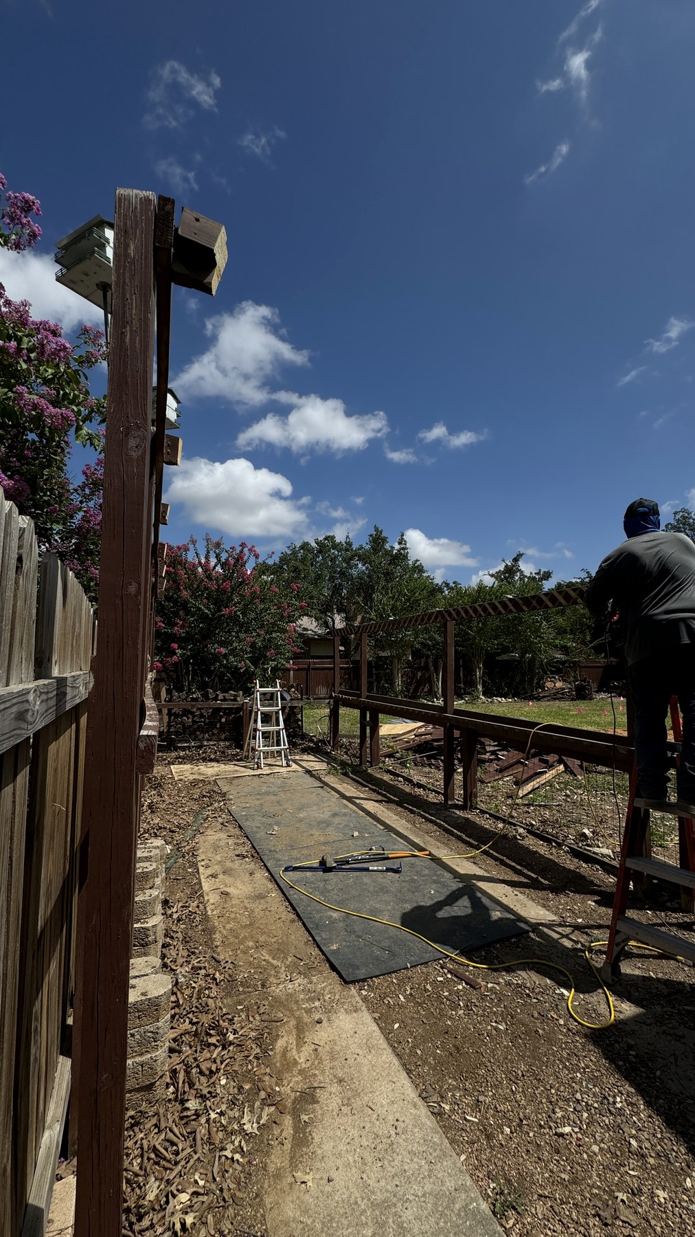 Remaining carport frame being dismantled